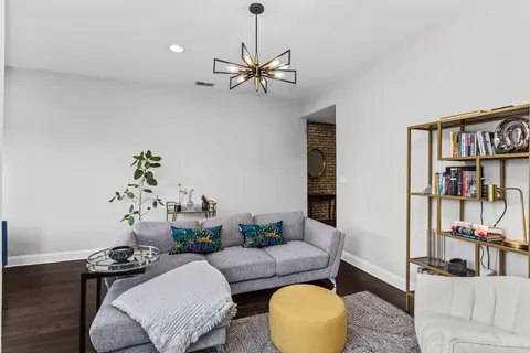 a living room with furniture and a book shelf