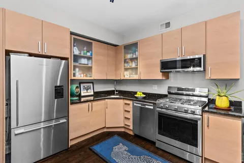 a kitchen with stainless steel appliances a refrigerator sink and microwave