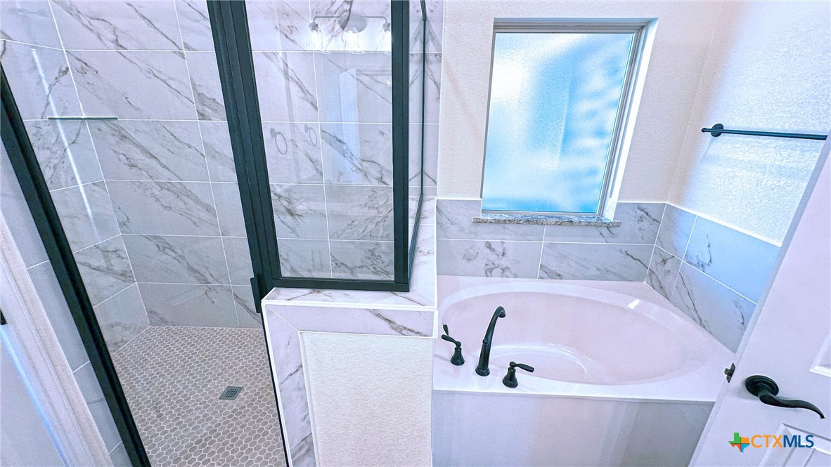 4237 Cool Basin Road Kempner, TX 76539 - Photo 28 of 36 a bath tub sitting in a bathroom next to a sink