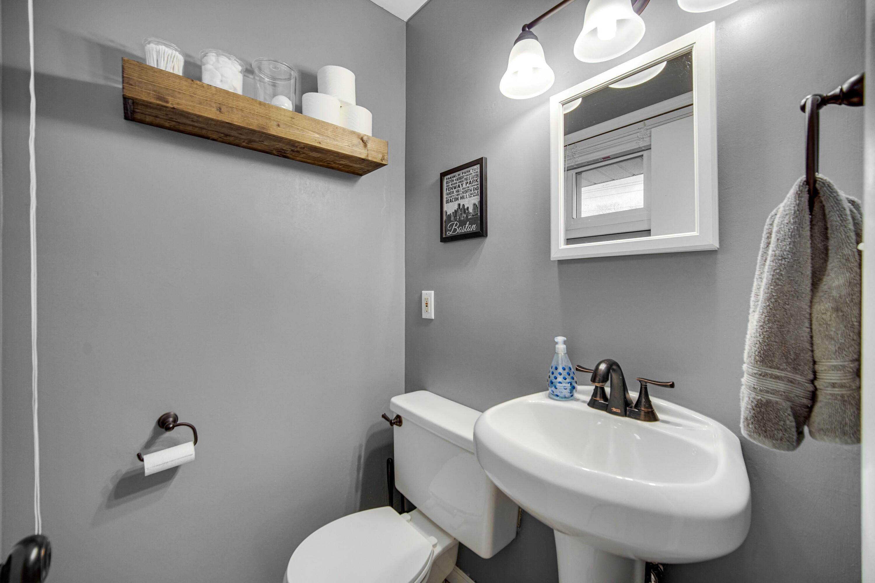 9418 Cleveland Street Crown Point, IN 46307 - Photo 11 of 22 a bathroom with a toilet sink and mirror