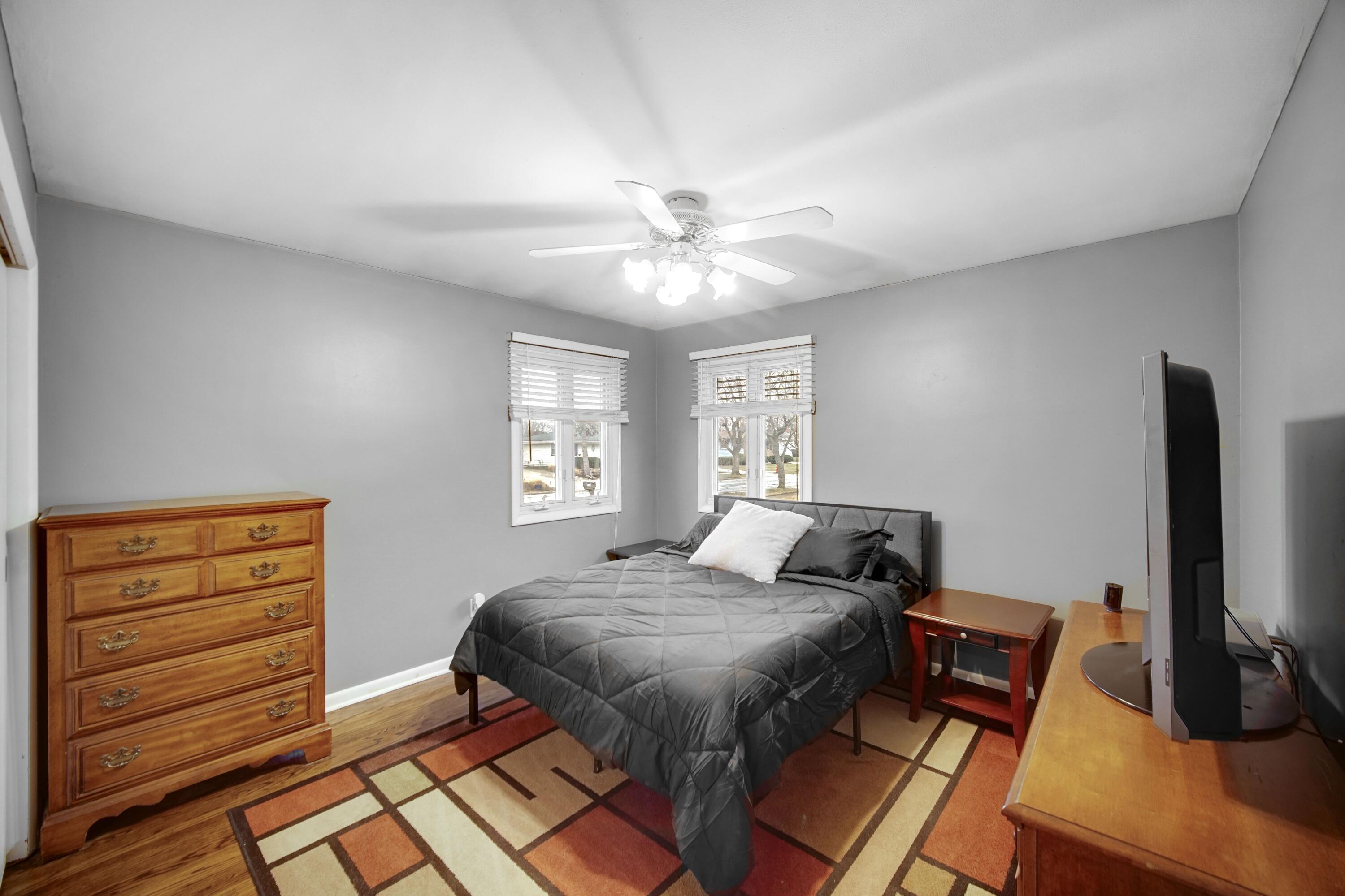 9418 Cleveland Street Crown Point, IN 46307 - Photo 12 of 22 a bedroom with a bed and a flat screen tv