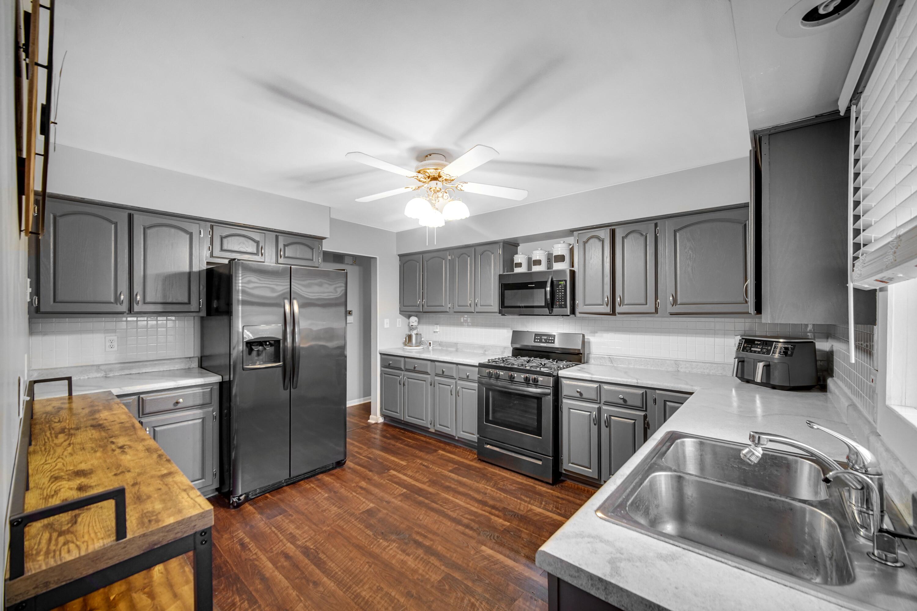 9418 Cleveland Street Crown Point, IN 46307 - Photo 6 of 22 a kitchen with stainless steel appliances granite countertop a sink stove and refrigerator
