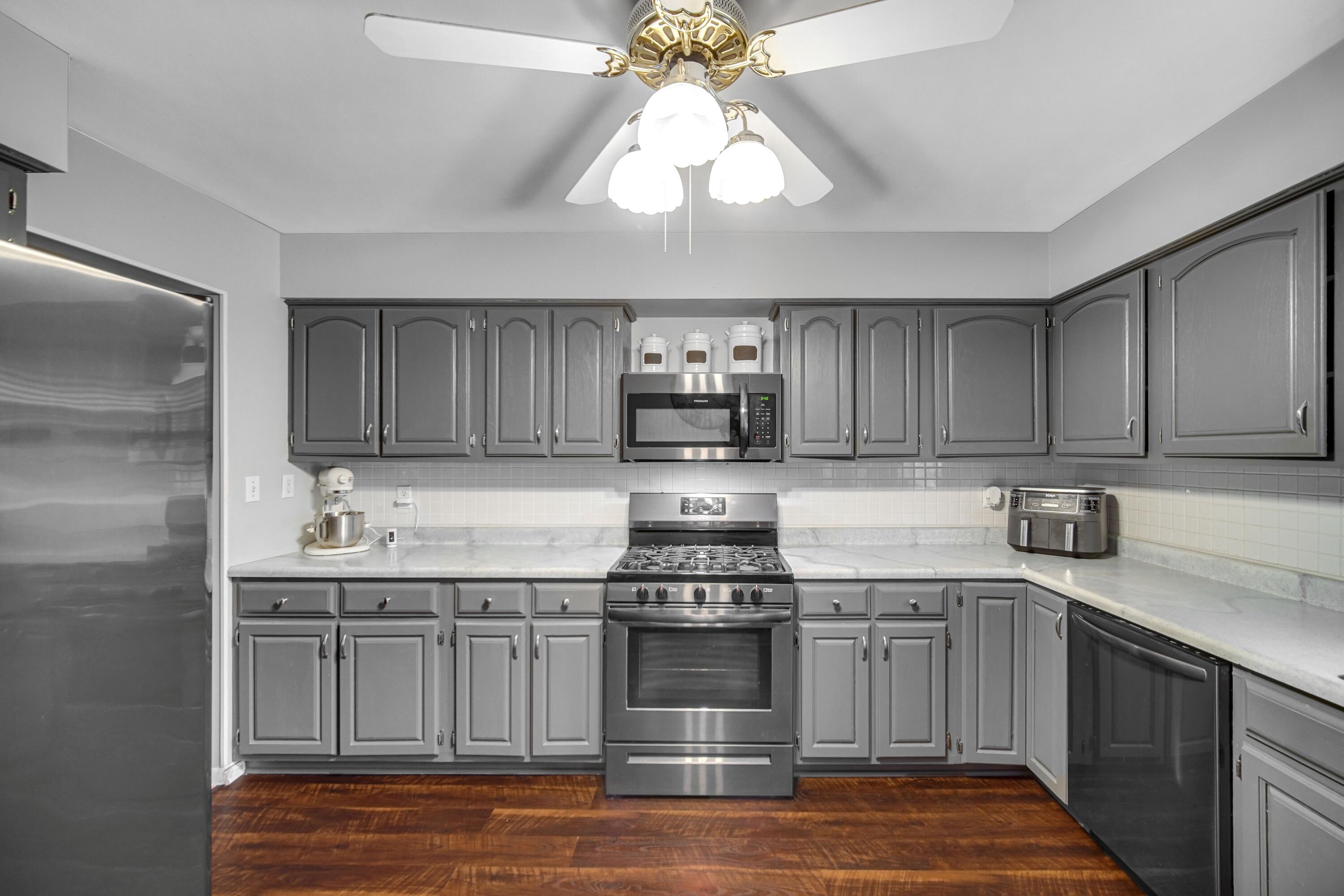 9418 Cleveland Street Crown Point, IN 46307 - Photo 8 of 22 a kitchen with stainless steel appliances granite countertop a sink and cabinets