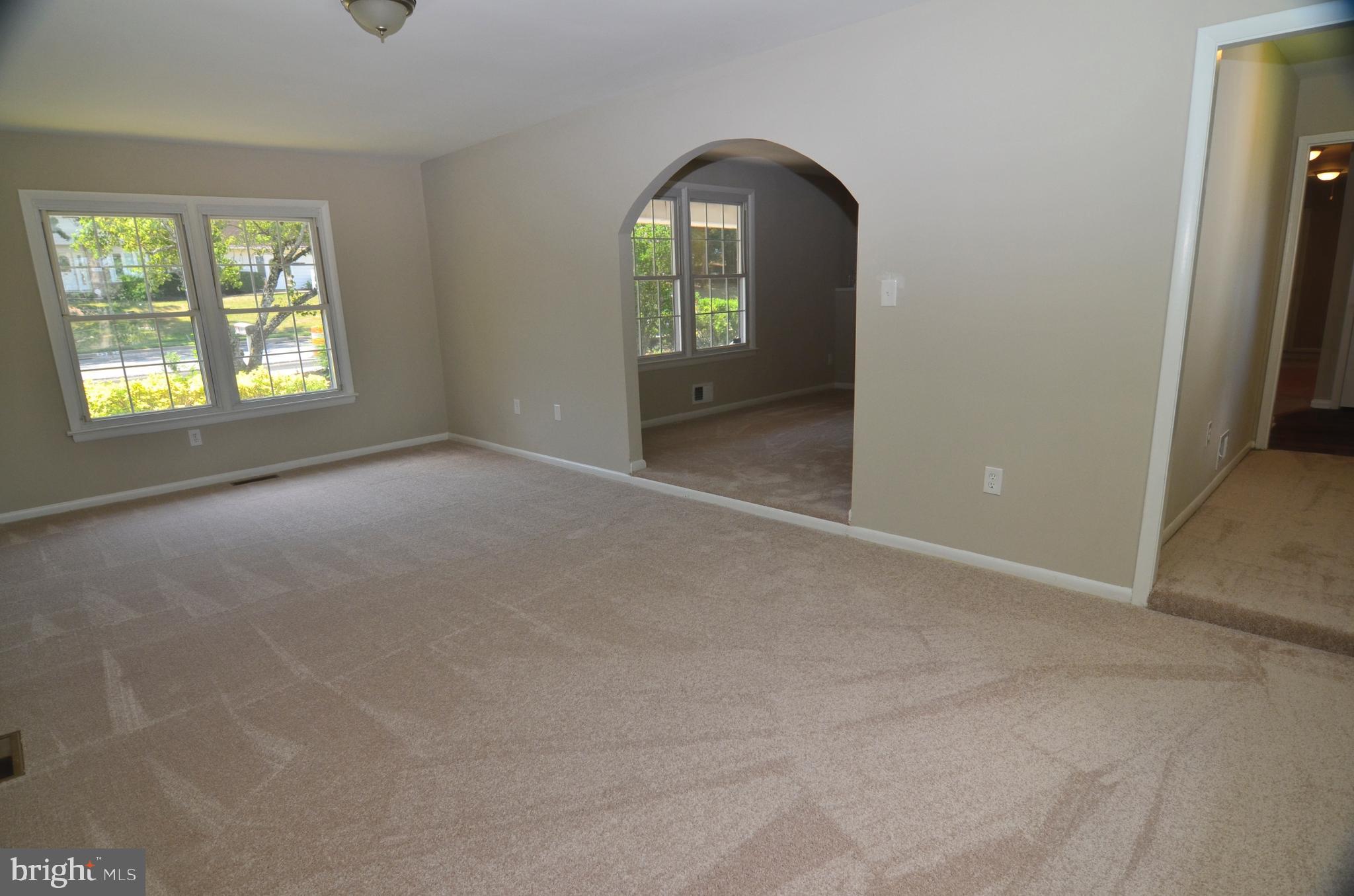 8604 Contee Road Laurel, MD 20708 - Photo 11 of 56 an empty room with windows and mirror