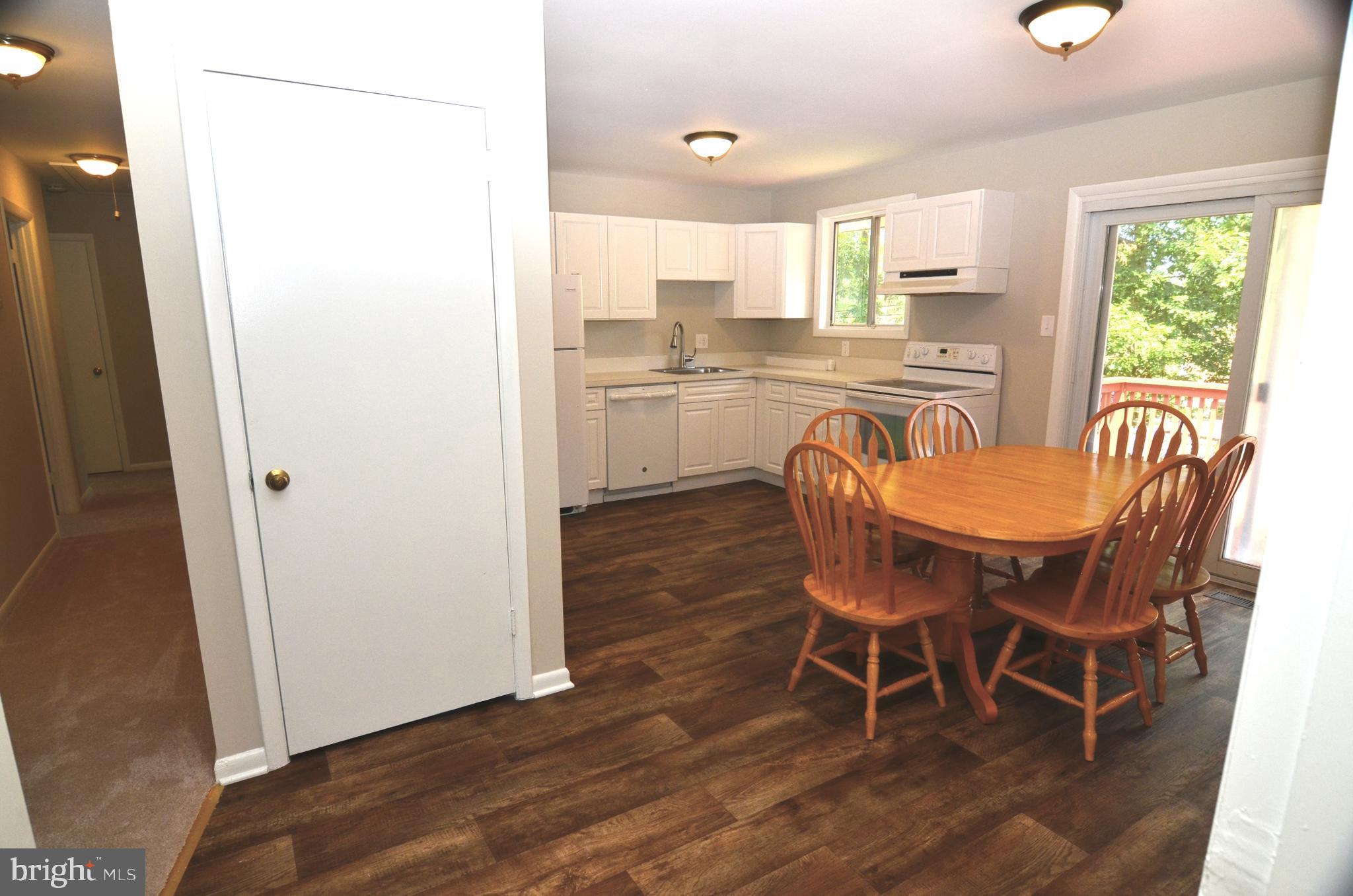 8604 Contee Road Laurel, MD 20708 - Photo 13 of 56 a dining room with furniture and wooden floor