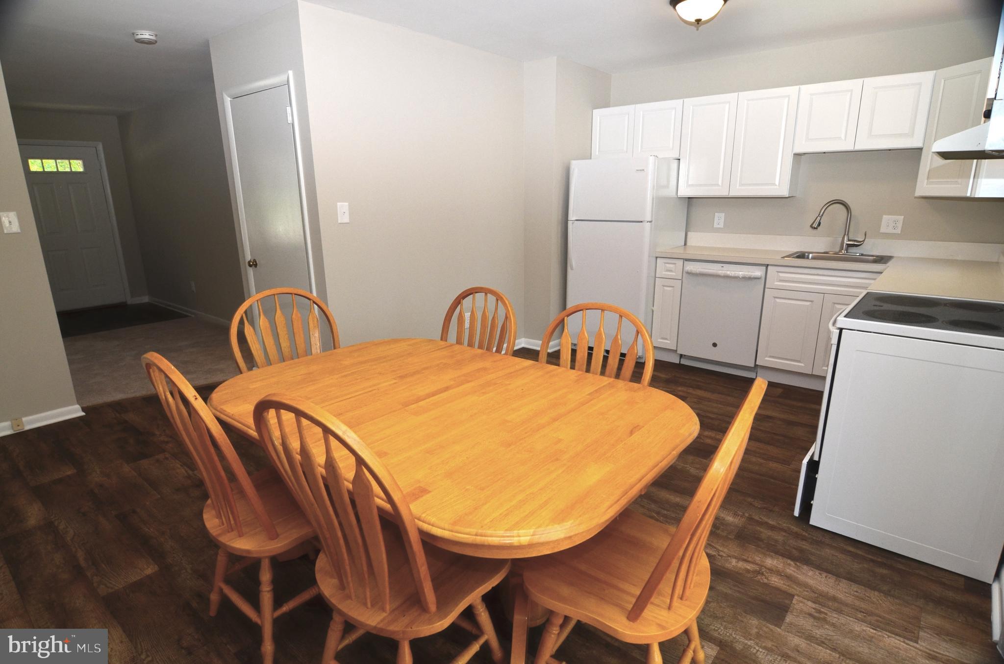 8604 Contee Road Laurel, MD 20708 - Photo 14 of 56 a view of a dining room with furniture and wooden floor