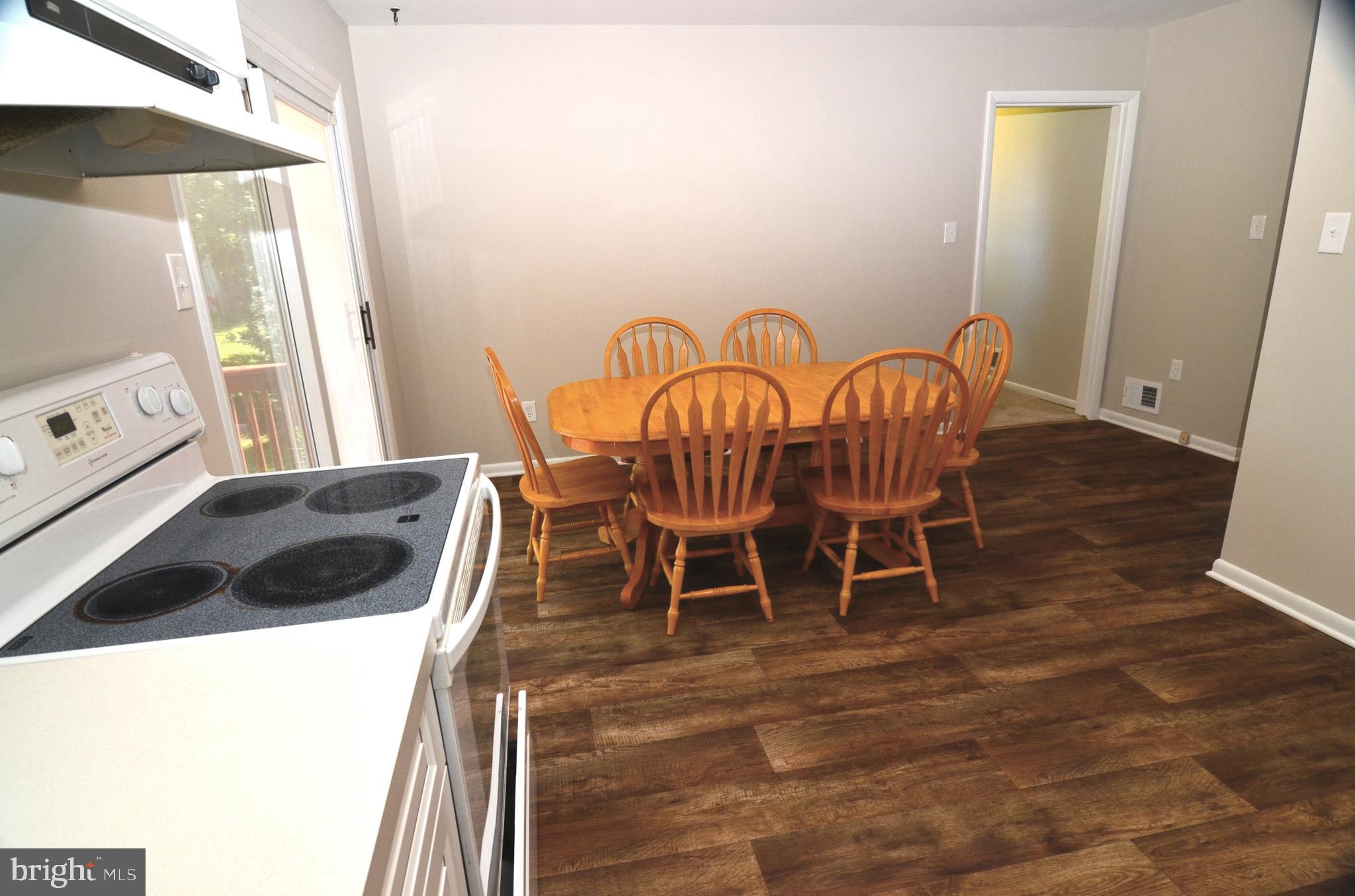 8604 Contee Road Laurel, MD 20708 - Photo 15 of 56 a view of a dining room with furniture and wooden floor