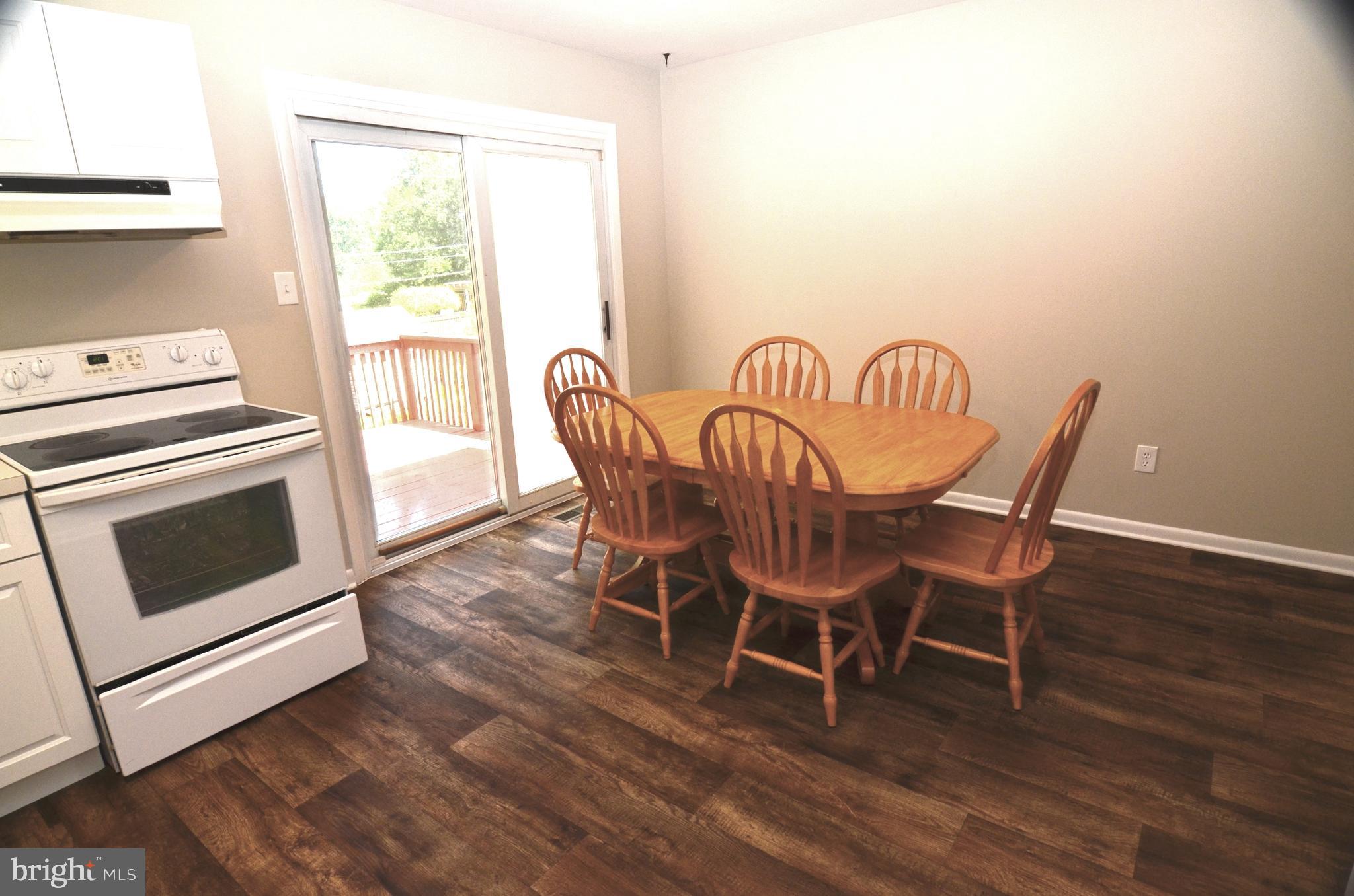 8604 Contee Road Laurel, MD 20708 - Photo 16 of 56 a view of a dining room with furniture window and wooden floor