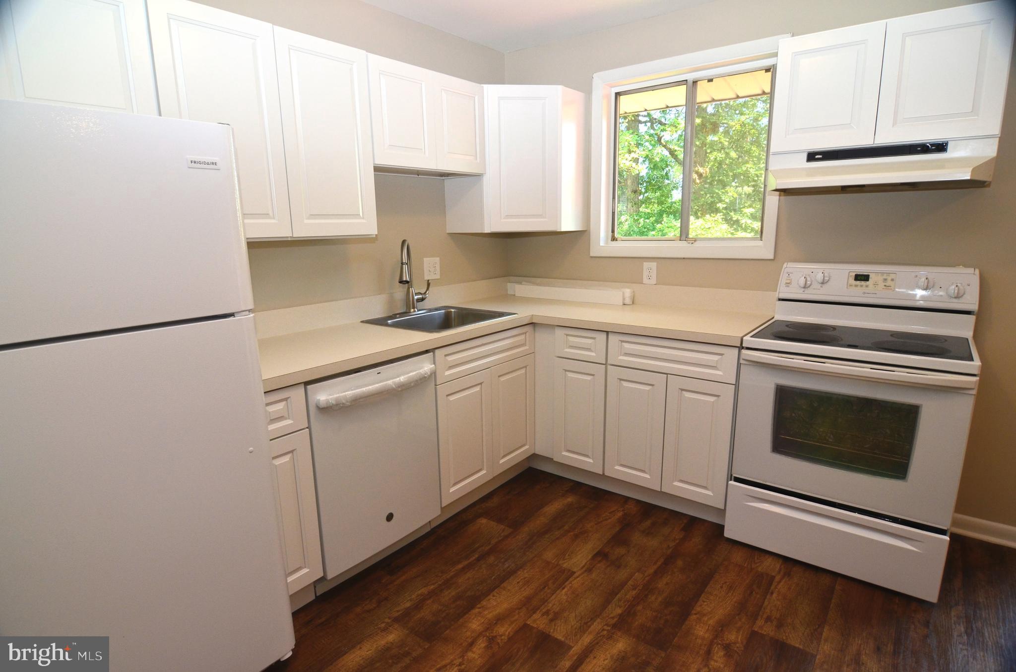 8604 Contee Road Laurel, MD 20708 - Photo 17 of 56 a kitchen with cabinets appliances a sink and a window