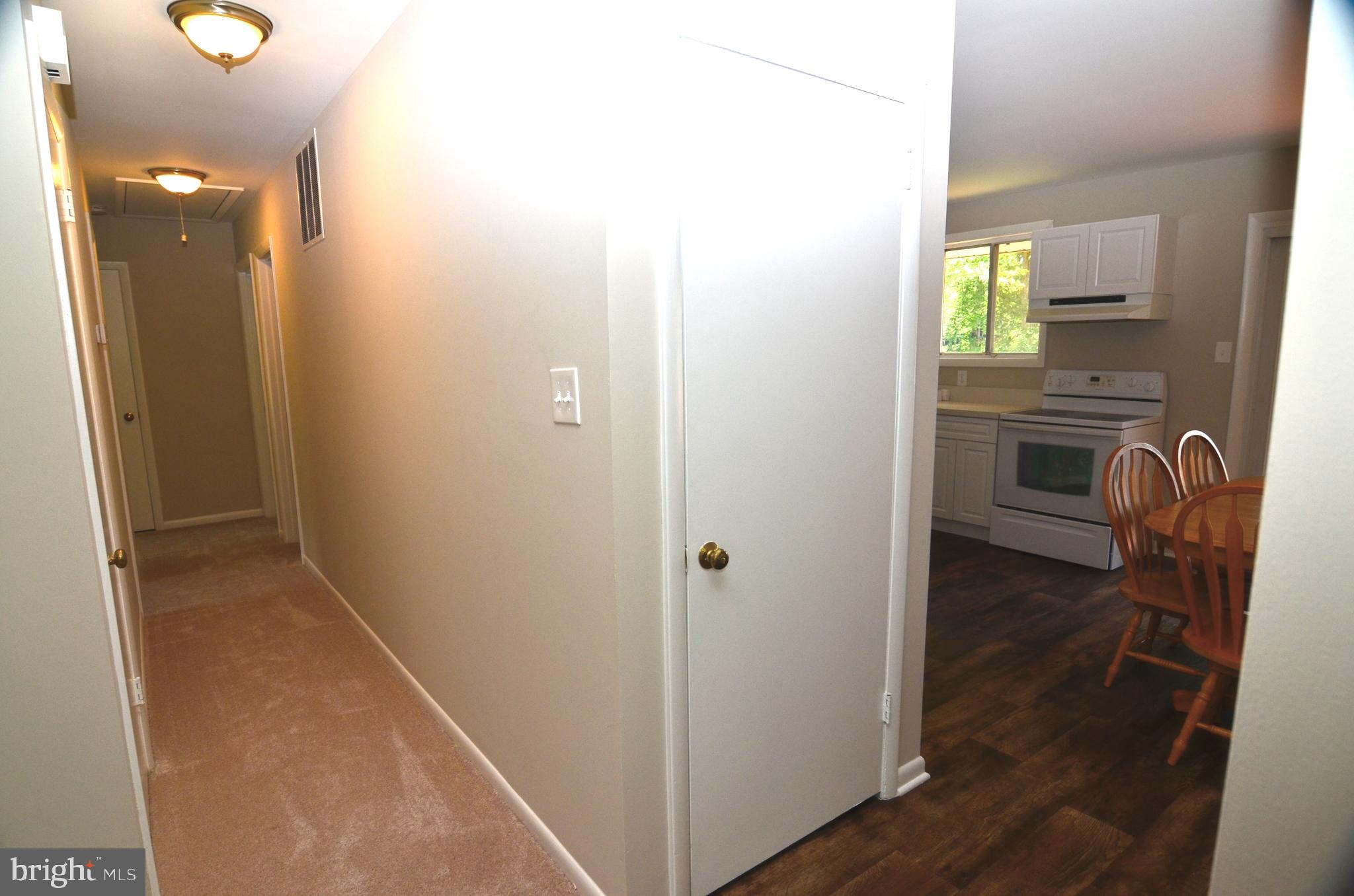 8604 Contee Road Laurel, MD 20708 - Photo 19 of 56 a view of a hallway with wooden floor