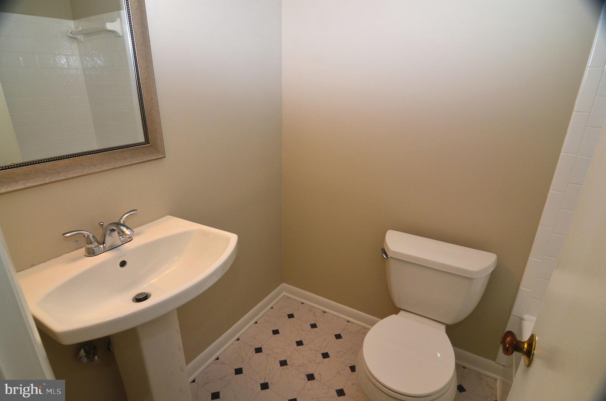 8604 Contee Road Laurel, MD 20708 - Photo 22 of 56 a white toilet sitting next to a bathroom sink