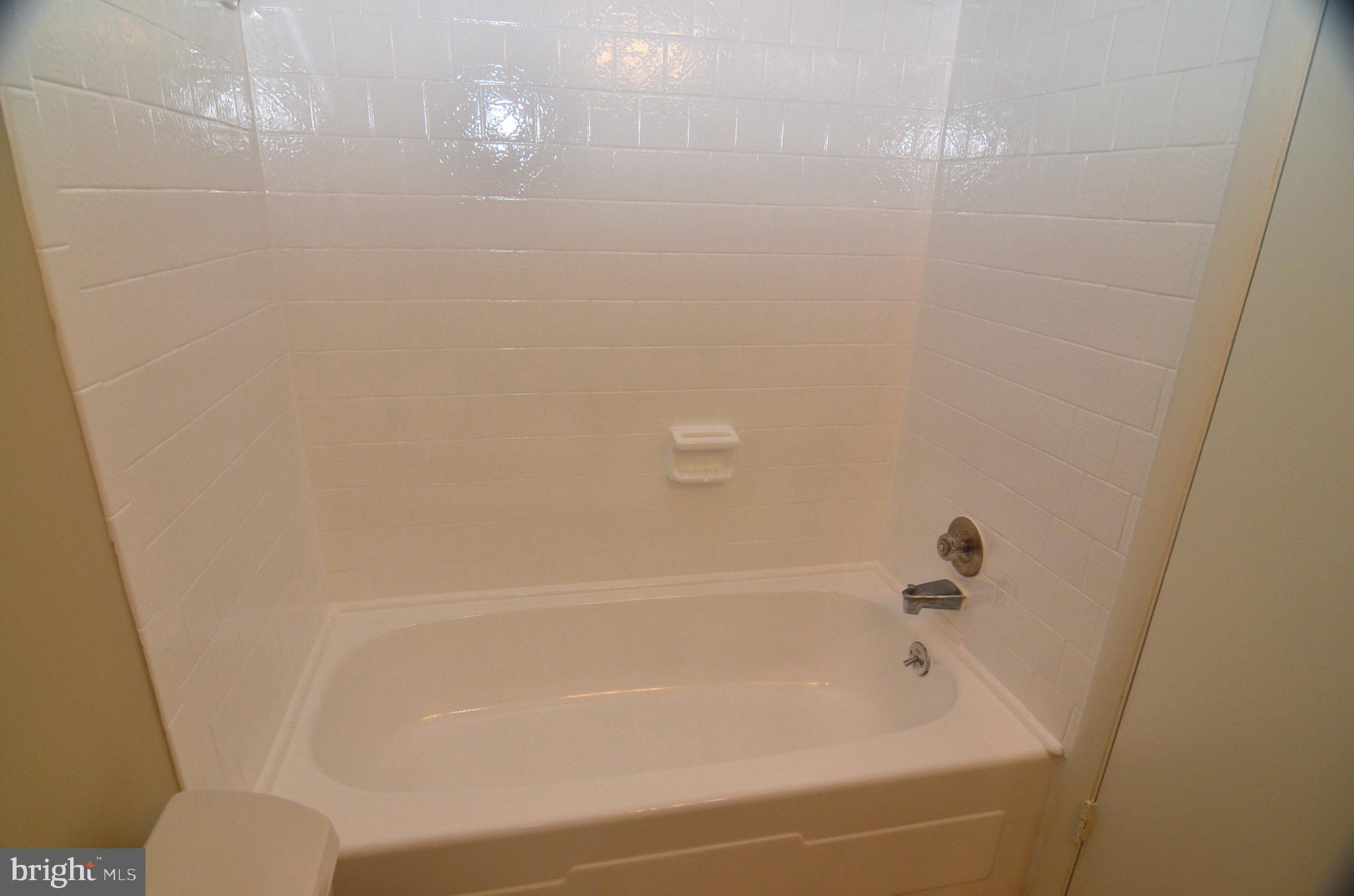 8604 Contee Road Laurel, MD 20708 - Photo 23 of 56 a bathroom with a bathtub