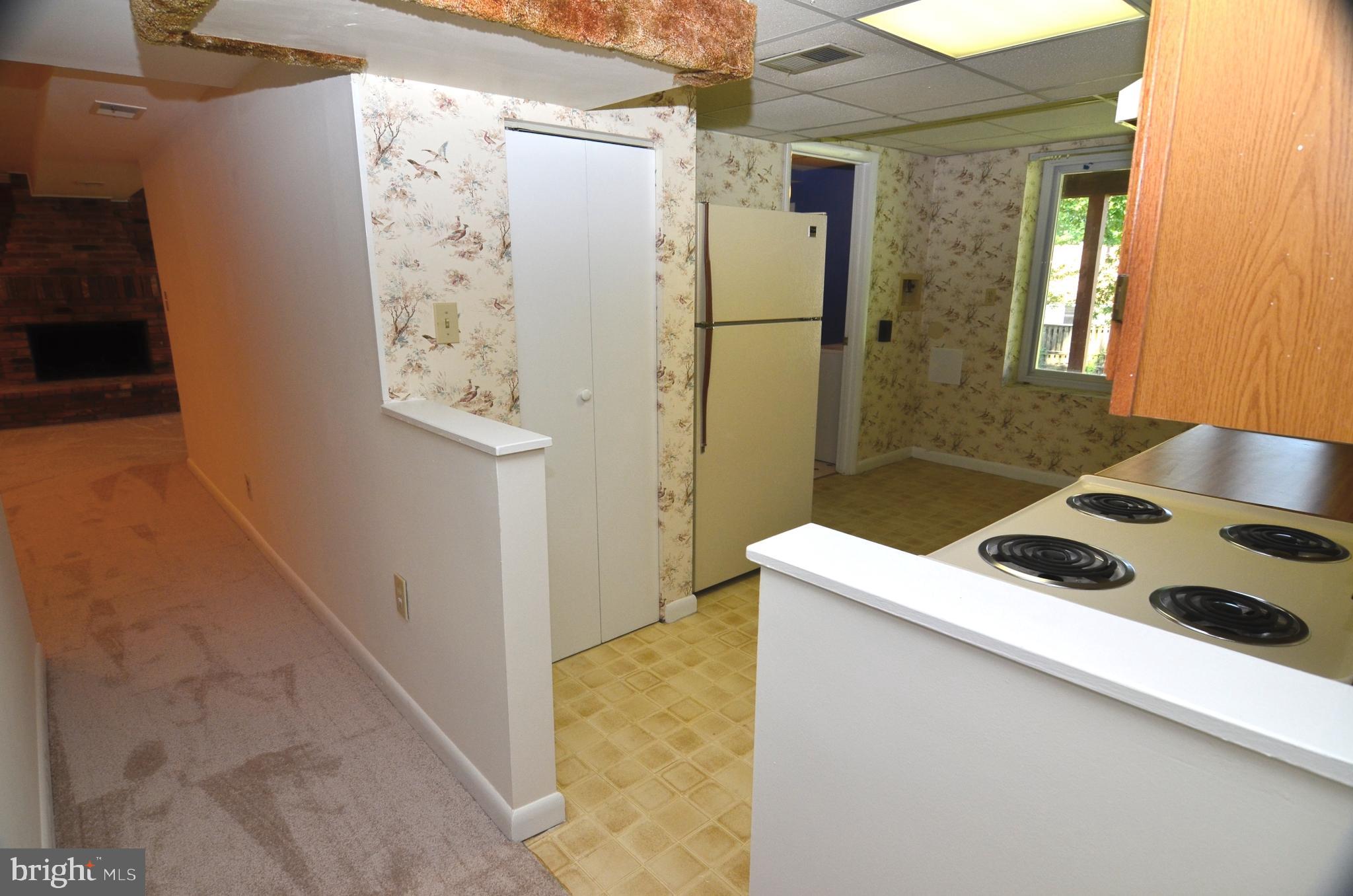 8604 Contee Road Laurel, MD 20708 - Photo 37 of 56 a kitchen with a refrigerator and a stove