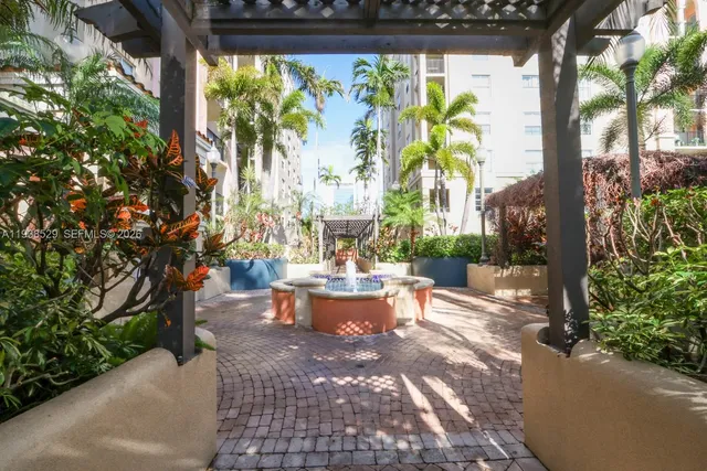 a view of a porch with chairs and a potted plant