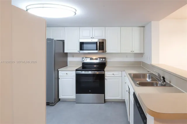 a kitchen with a sink stove and refrigerator