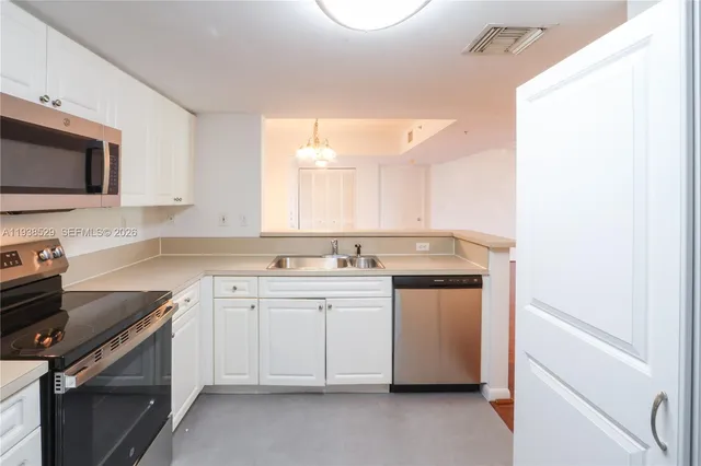 a kitchen with a sink stove and microwave