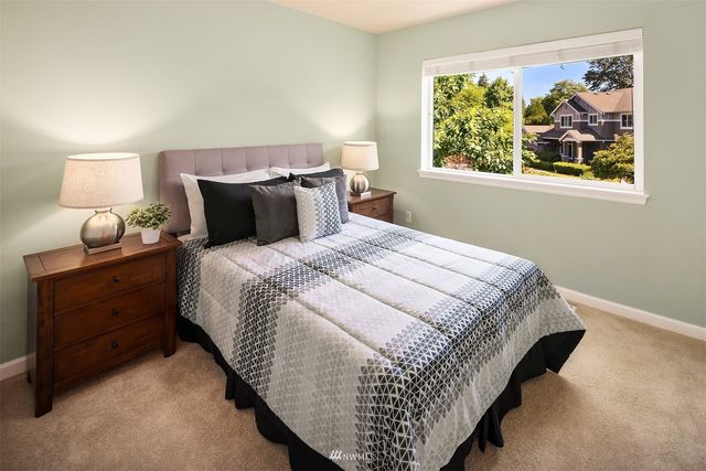 a bed sitting in a bedroom next to a window