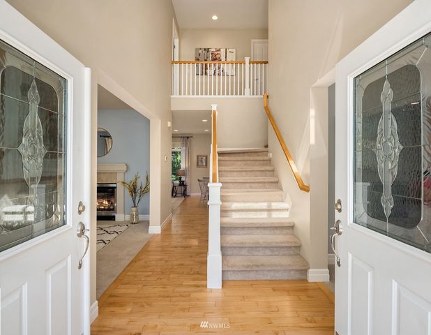 a view of entryway and hall with wooden floor