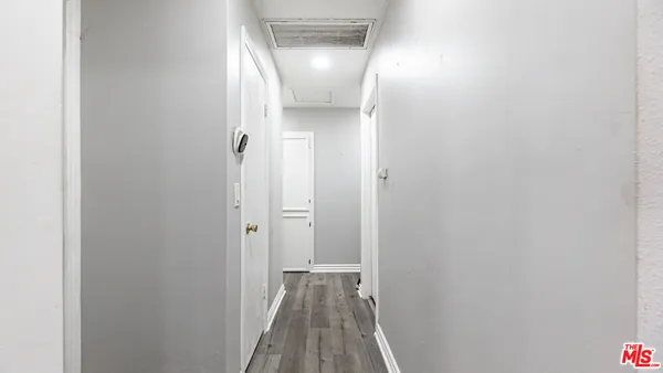 a view of a hallway with wooden floor