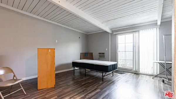 a living room with furniture a table and large window