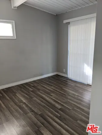 a view of room with wooden floor