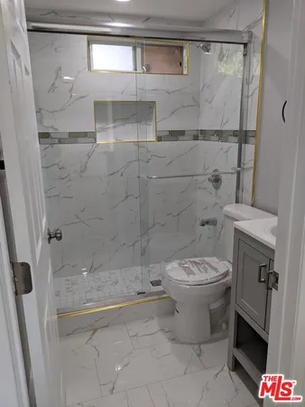 a bathroom with a toilet and a shower