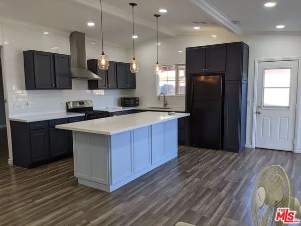 a kitchen with a sink a refrigerator and a stove