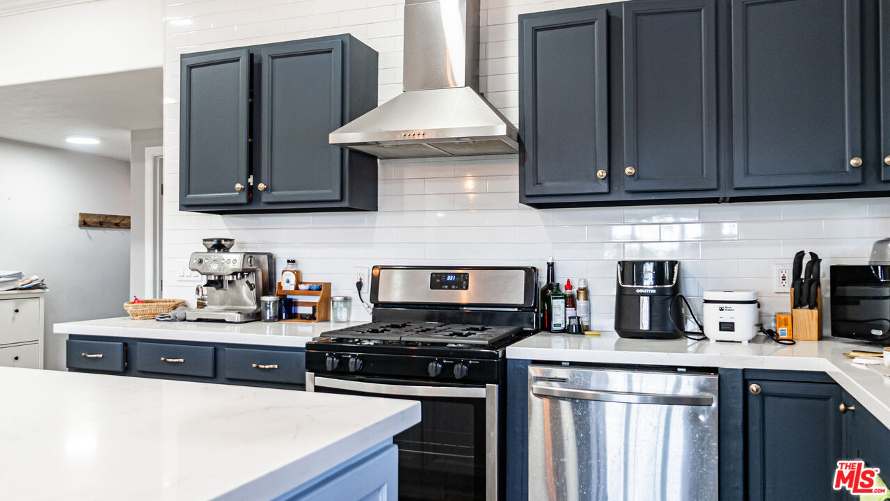 892 Vassar Street Pomona, CA 91767 - Photo 6 of 28 a kitchen with stainless steel appliances granite countertop a stove a sink and a microwave