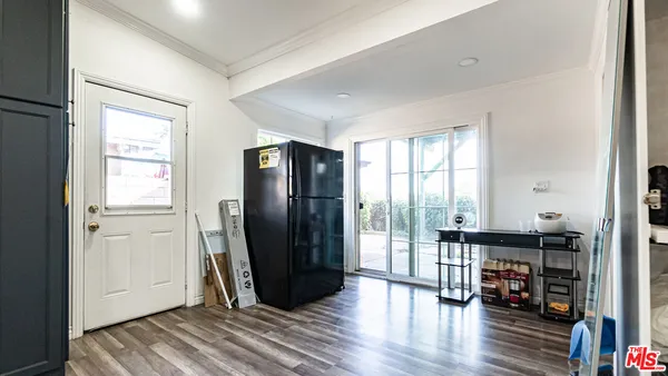 a view of a livingroom with wooden floor and furniture