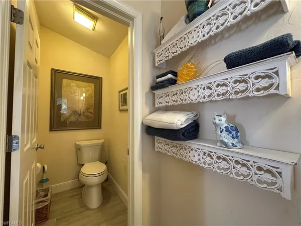 a bathroom with a toilet a sink and a mirror