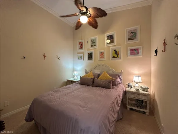 a bedroom with a bed and a ceiling fan