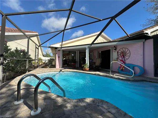 a view of swimming pool with outdoor seating
