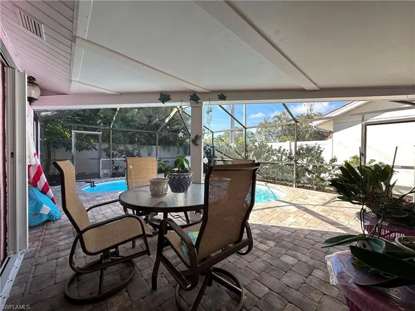 a view of a porch with chairs and backyard