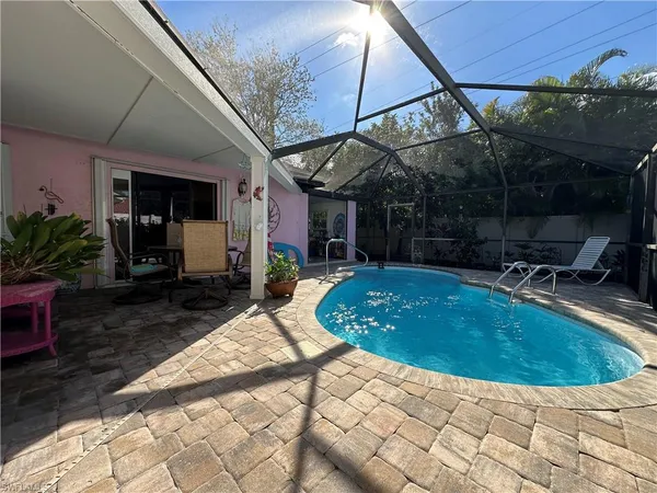 a view of a backyard with plants and patio