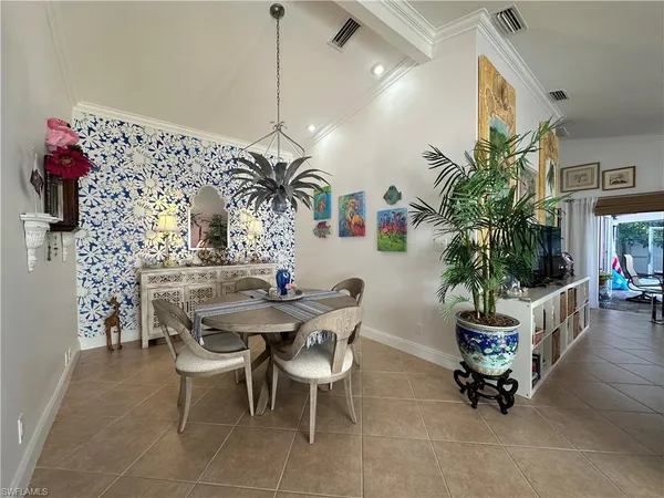 a dining room with furniture and a chandelier