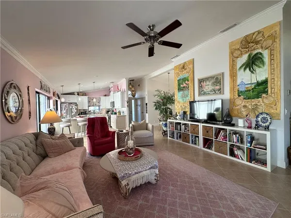 a living room with furniture and a large window with wooden floor