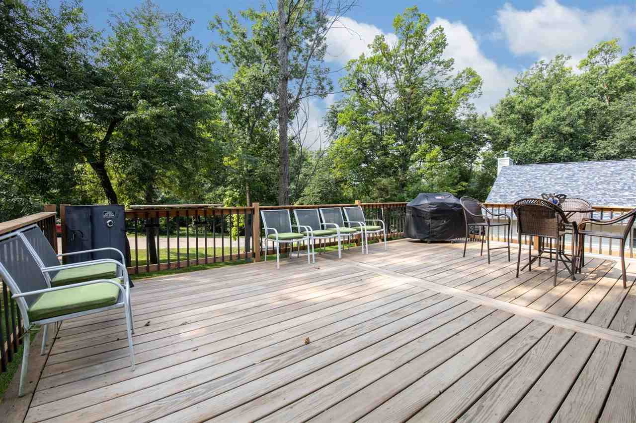 1088 Winborne Road Lake Summerset, IL 61019 - Photo 19 of 22 a view of a roof deck with table and chairs a barbeque with wooden floor and fence