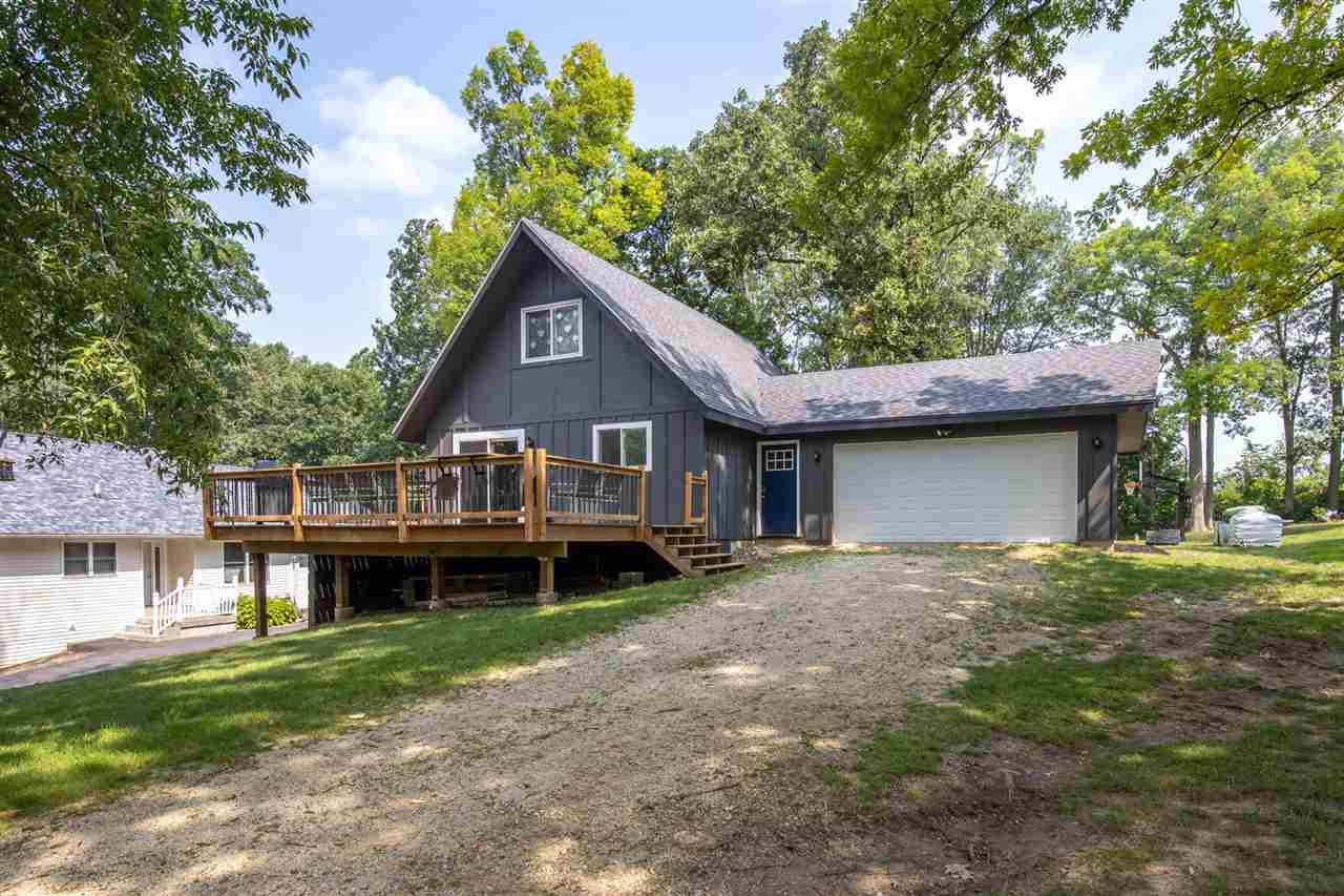 1088 Winborne Road Lake Summerset, IL 61019 - Photo 3 of 22 a front view of a house with a garden and deck