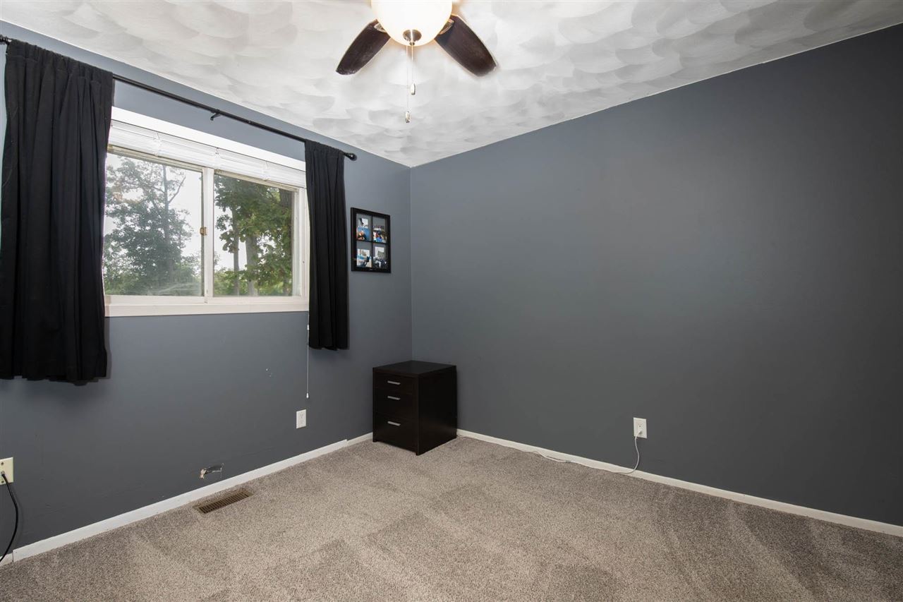 1088 Winborne Road Lake Summerset, IL 61019 - Photo 8 of 22 an empty room with windows and fan