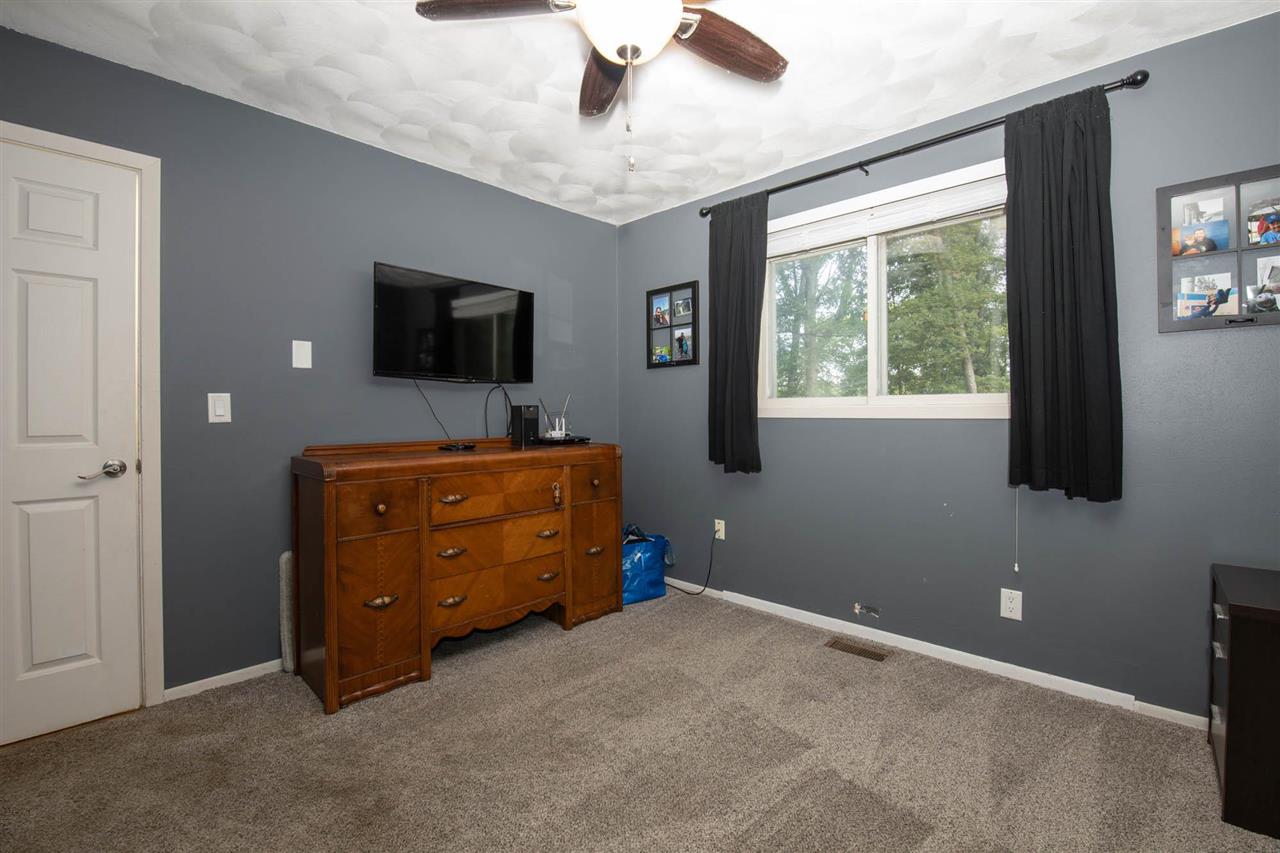 1088 Winborne Road Lake Summerset, IL 61019 - Photo 9 of 22 a bedroom with a bed and flat screen tv