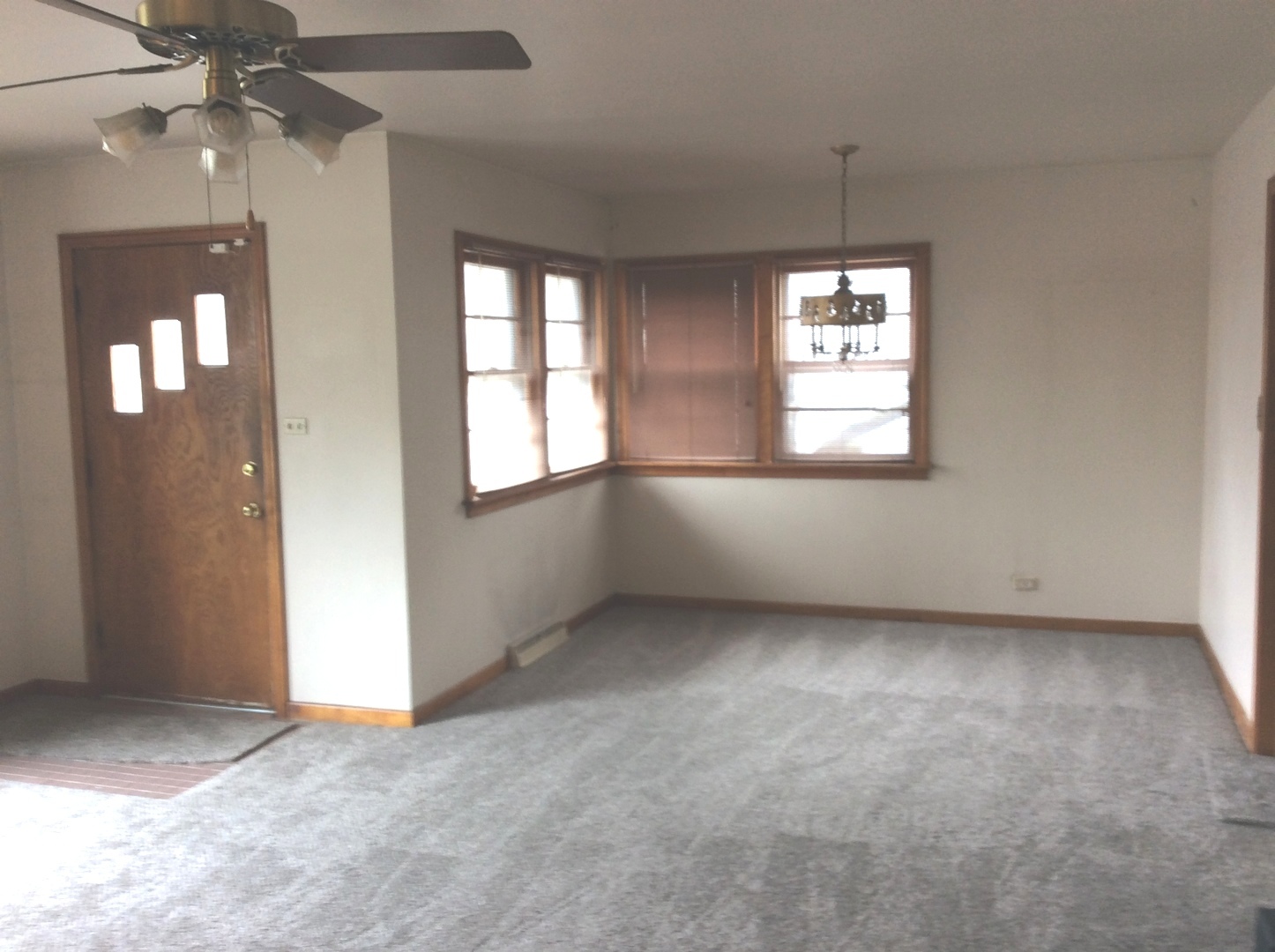 1436 Evergreen Road Homewood, IL 60430 - Photo 3 of 32 an empty room with chandelier fan and windows