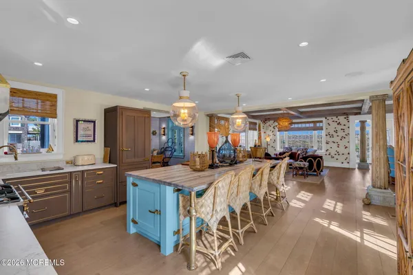 a kitchen with stainless steel appliances granite countertop a sink counter space and living room view