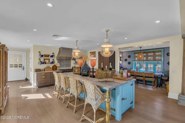 a view of a dining room with furniture wooden floor and a chandelier