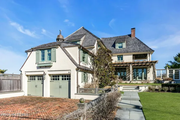 a front view of a house with a garden and yard