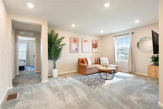 a living room with furniture and a large window