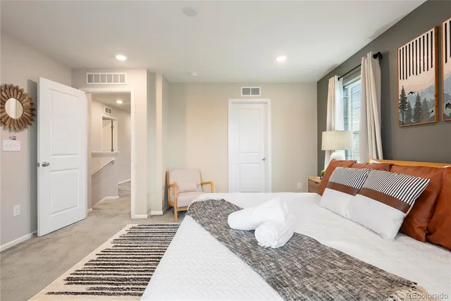 a bedroom with a large bed and a window