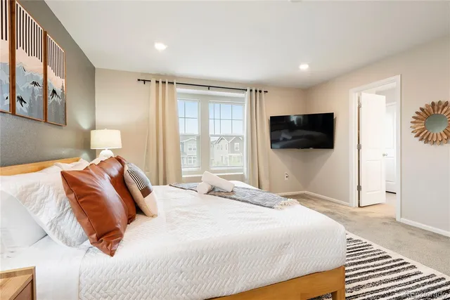 a bedroom with a bed and a flat screen tv