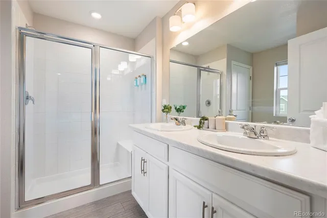 a bathroom with a double vanity sink mirror and double