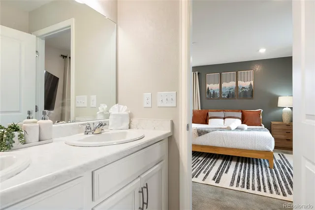 a en suite bathroom with a double vanity sink and a mirror