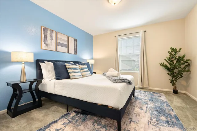 a bedroom with bed and a potted plant